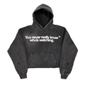 Black hoodie with text 'You never really know who's watching' on a white background