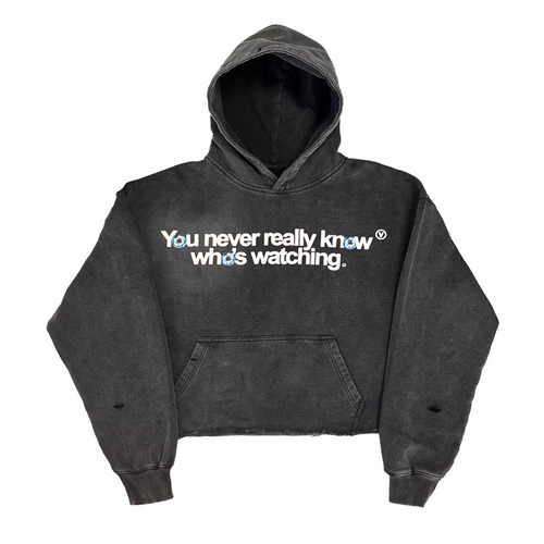 Black hoodie with text 'You never really know who's watching' on a white background