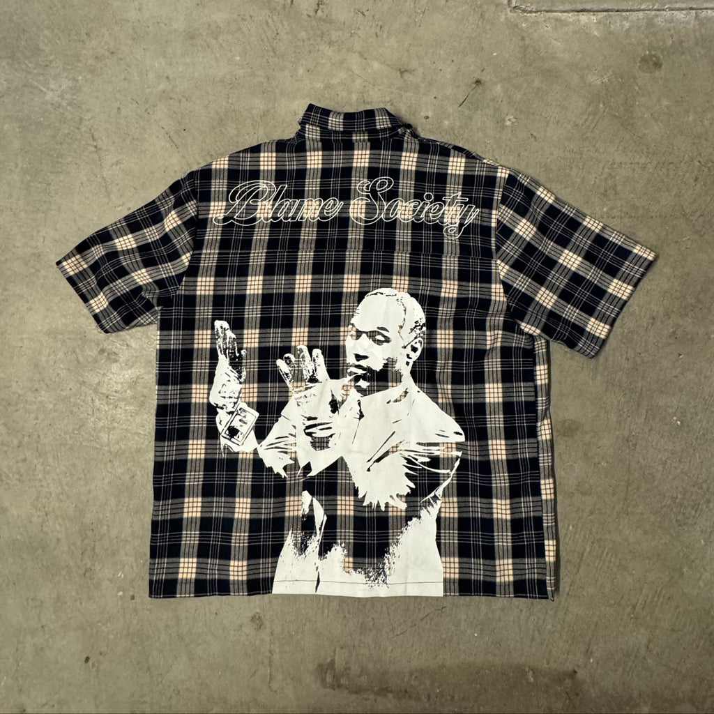Plaid shirt with graphic design on a concrete surface